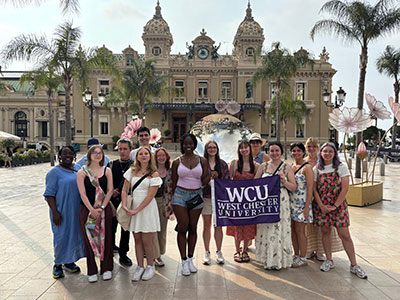 WCU students in Lyon, France holding WCU banner