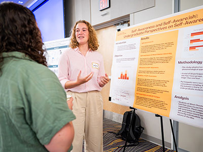Photo of Layla King presenting her research poster