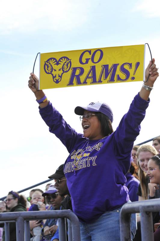 student holding Rams Up sign