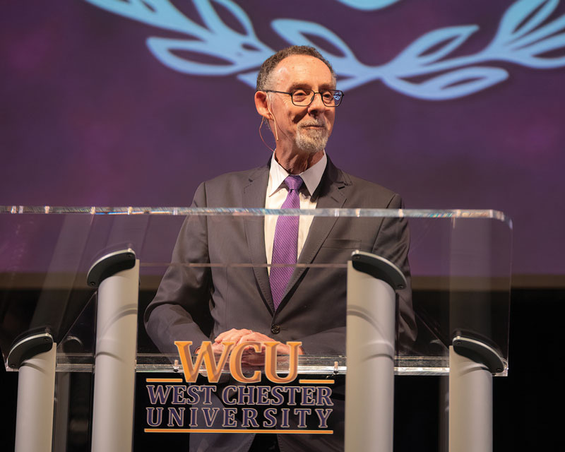 Christopher Fiorentino giving Welcome Back Address on stage behind WCU podium