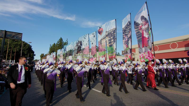 West Chester University Incomparable Golden Rams (Marching Band) in a parade. Photo is taken from ground level.