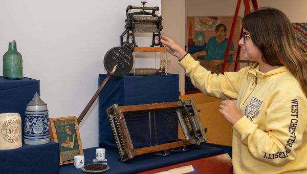 Jacqueline Armao, a museum studies minor, works on her exhibit featuring Philadelphia’s culinary heritage. Among the artifacts are 2 century-old pasta makers and a pizzelle maker, Chinese tea and teacups, 18th and 19th century German beer steins, and Philadelphia-made glass bottles from the colonial era.