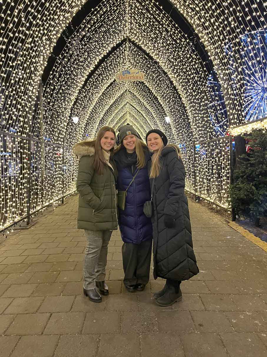 group smiling underneath lights