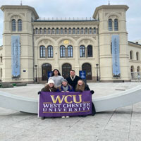 Group posing with WCU flag