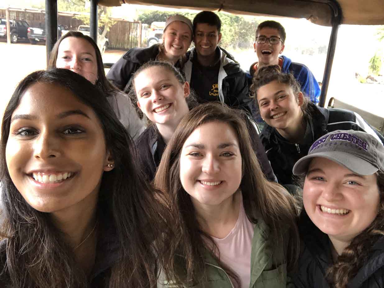 Group smiling in car