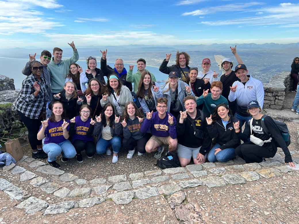 Group posing with ramsup hand gesture