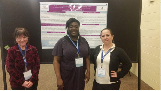 3 women standing in front of a poster.