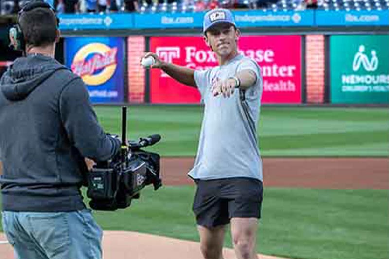 Thumbnail: Close up photo of Jake Welsch throwing the first pitch
