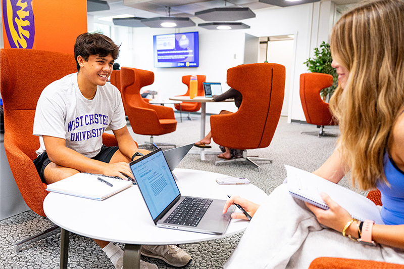 Two students studying at a desk