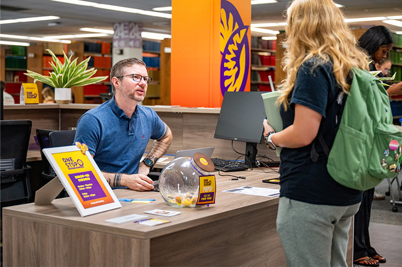 Student getting help at one stop service desk