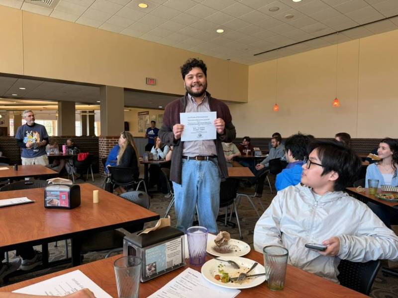 CS Student with award certificate