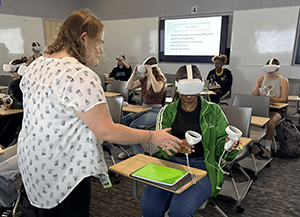 Jes Drass demonstrates how to use VR headsets.